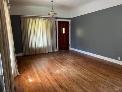 Entryway featuring dark wood-style flooring and baseboards