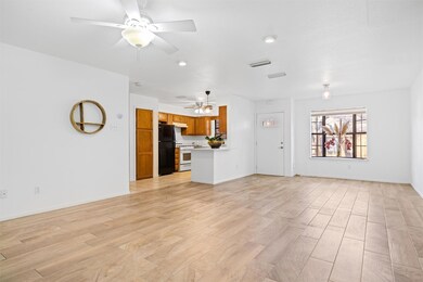 Unfurnished living room with light wood-style flooring and a ceiling fan