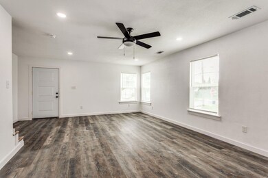 Empty room with ceiling fan and dark hardwood / wo