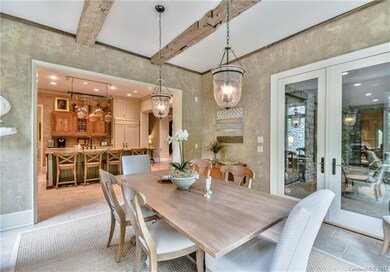 Formal dining room with exposed wood beams and vie