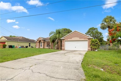 Ranch-style home with a front lawn and a garage