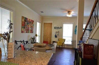 Kitchen with ceiling fan, dark wood-type flooring