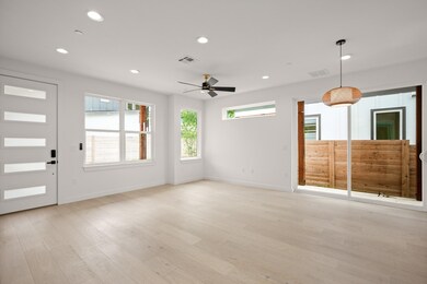 Unfurnished living room featuring ceiling fan, re