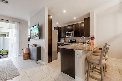 Kitchen featuring stainless steel appliances, ligh