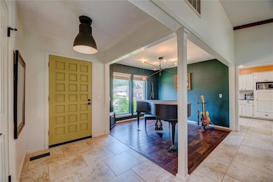 Entrance foyer with baseboards and decorative columns