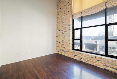 Spare room with baseboards and wood finished floo
