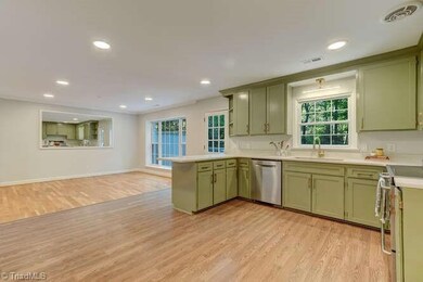 An open floor plan opens to the large dining area, and a doorway to the double deck allow for easy flow for living, hosting, and entertaining.