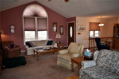 Front door entry into living area; vaulted ceiling