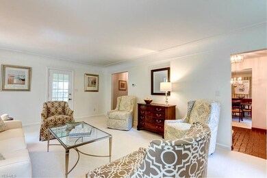 Glass door leads to enclosed sun room. New Carpet 