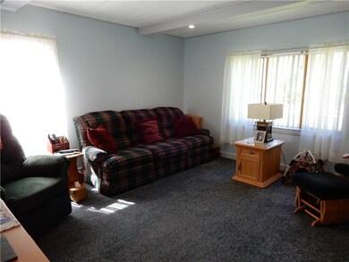 Living Room is bright and cheerful with multiple w