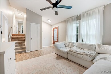 Living room featuring baseboards, light wood-type