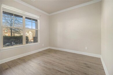 Spare room featuring ornamental molding and wood finished floors