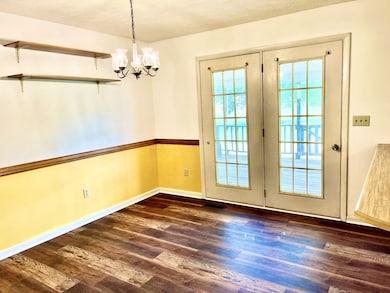Dining room with french doors leading to a covered deck.