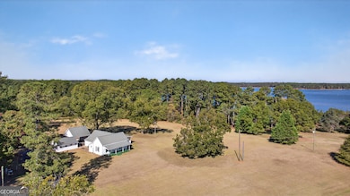 Aerial close up of land and lake to side
