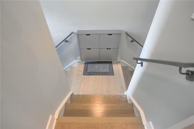 The entryway sets a clean and modern tone with lig