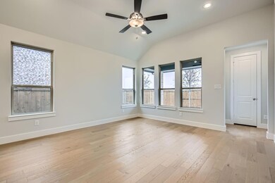 Unfurnished room featuring lofted ceiling, light h