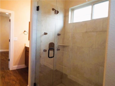 Full bath with wood finished floors, a shower sta