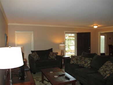 Spacious living room with large entry by front doo