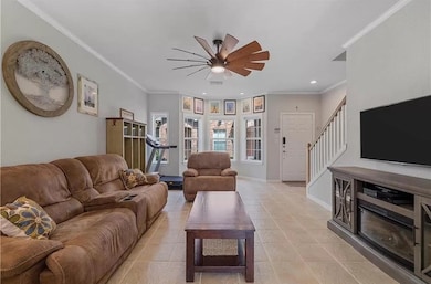 Living room featuring crown molding, stairway, light tile patterned floors, recessed lighting, and ceiling fan