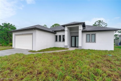 Prairie-style home with a garage, stucco siding, c