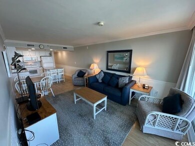 Living room with crown molding and wood-type flooring