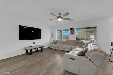 Living room featuring a ceiling fan