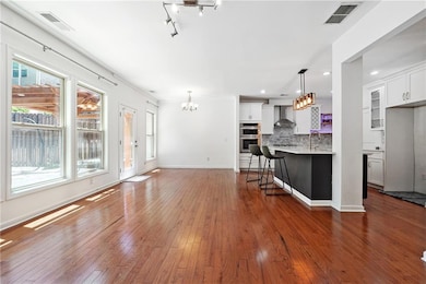 Kitchen with wall chimney range hood, double oven,
