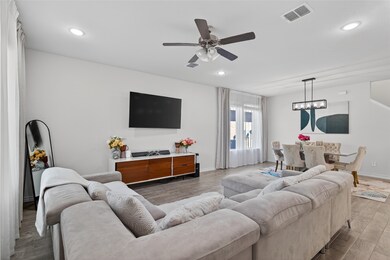 Living area with ceiling fan, and recessed lighting