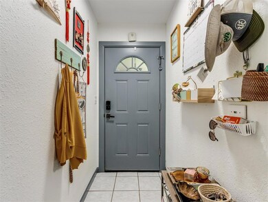 Doorway featuring light tile patterned flooring
