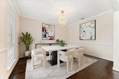 Dining room features custom molding and hardwood f