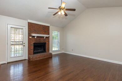 Unfurnished living room featuring dark wood-type f