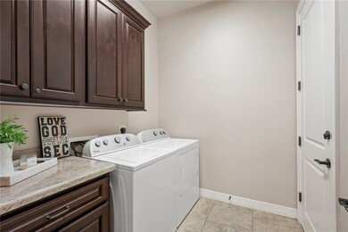 Laundry area featuring cabinet space, washing mach