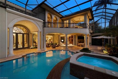 Back of house with a pool with hot tub, a patio ar