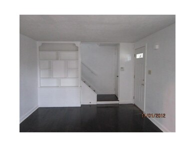 Living Room. Great built-ins along with the beautiful hardwood.  The nicely done stairs even accent the room.
