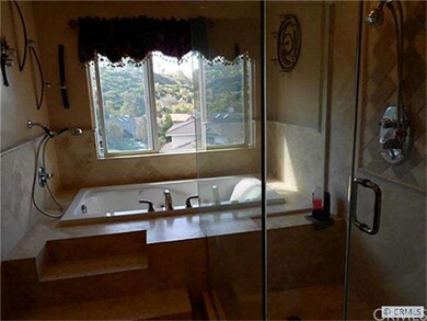 Custom designed travertine bathrooms, step-up over