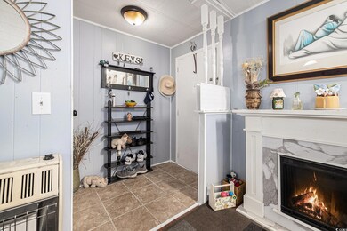 Interior space with heating unit, crown molding, and a premium fireplace