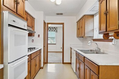 Original kitchen with white appliances.  Gas cookt