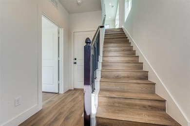 Staircase featuring hardwood / wood-style floors