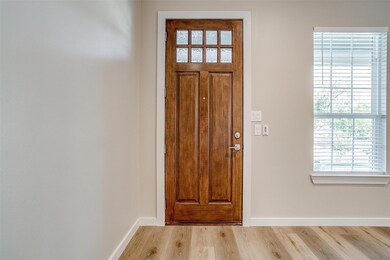 Entrance foyer with light hardwood / wood-style fl