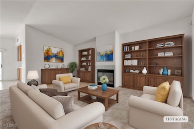 Living room featuring a tile fireplace, built in s
