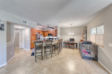 Dining space with light tile patterned floors and