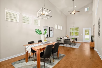 Dining space with ceiling fan, wood finished floo