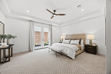 This bedroom features a modern, spacious design wi