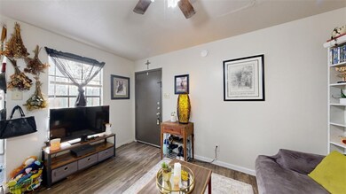 Living area featuring dark wood-style floors, ceil