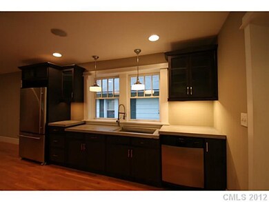Kitchen - Concrete countertops, charcoal cabinetry