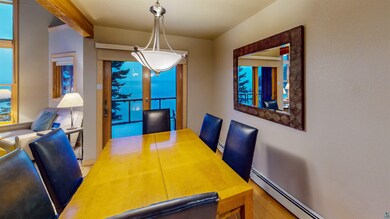 Dining room featuring baseboard heating, light har