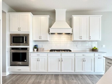 **Home for sale does not have wood hood.  Quartz countertops, stunning backsplash, and more cabinet and counter space than you can imagine! Welcome to the family chef's dream!!