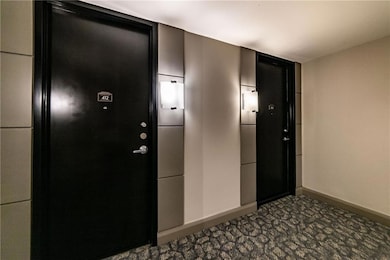 Hall with baseboards and dark carpet