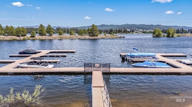Dock featuring a water and mountain view