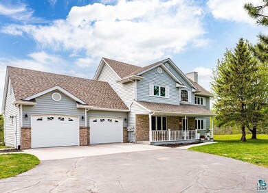 View of front of home featuring a front lawn, a ga